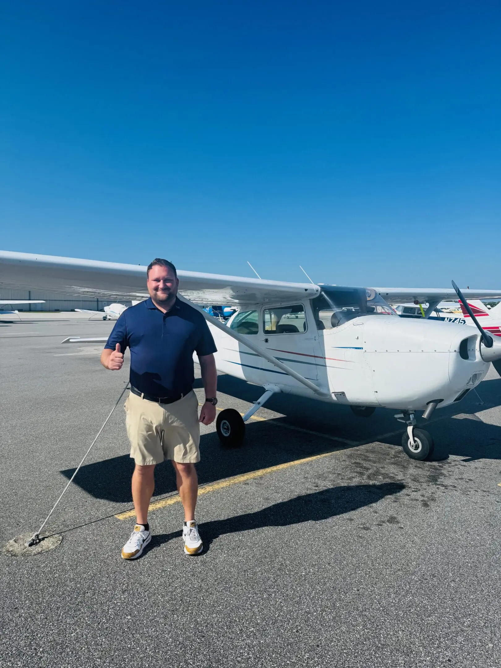 A man standing in front of an airplane.