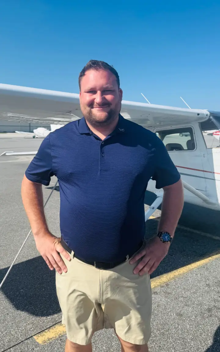 A man standing in front of an airplane.
